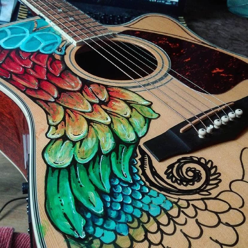 A hand-painted acoustic dreadnought guitar.